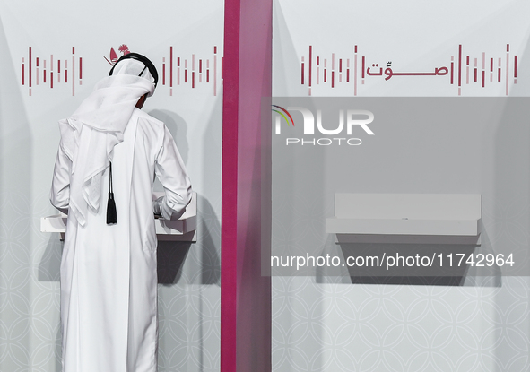 A Qatari man casts his ballot at a polling station in a general referendum on constitutional amendments, including scrapping advisory counci...