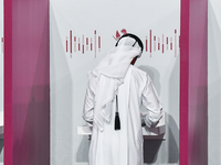 A Qatari man casts his ballot at a polling station in a general referendum on constitutional amendments, including scrapping advisory counci...