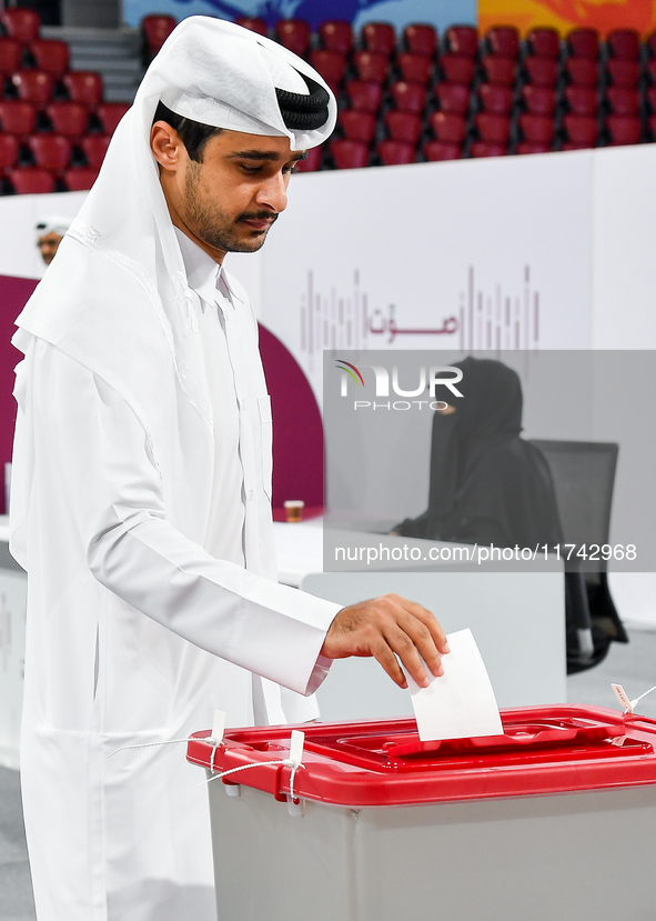 A Qatari man casts his ballot at a polling station in a general referendum on constitutional amendments, including scrapping advisory counci...