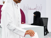 A Qatari man casts his ballot at a polling station in a general referendum on constitutional amendments, including scrapping advisory counci...