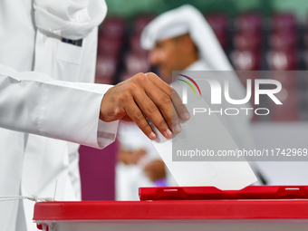 A Qatari man casts his ballot at a polling station in a general referendum on constitutional amendments, including scrapping advisory counci...