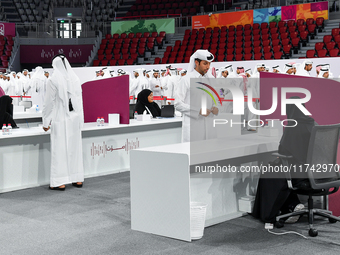 An electoral official checks the identification of a voter at a polling station to take part in a general referendum on constitutional amend...