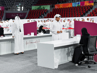 An electoral official checks the identification of a voter at a polling station to take part in a general referendum on constitutional amend...