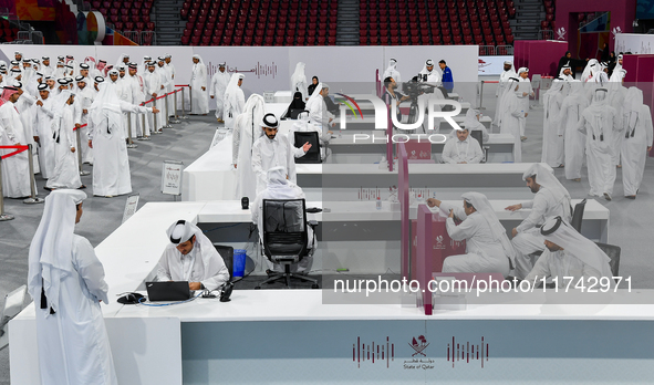 An electoral official checks the identification of a voter at a polling station to take part in a general referendum on constitutional amend...