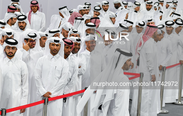 Qatari men wait in long queues to vote at a polling station in Doha, Qatar, on November 5, 2024, to cast their votes in a general referendum...