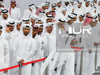 Qatari men wait in long queues to vote at a polling station in Doha, Qatar, on November 5, 2024, to cast their votes in a general referendum...