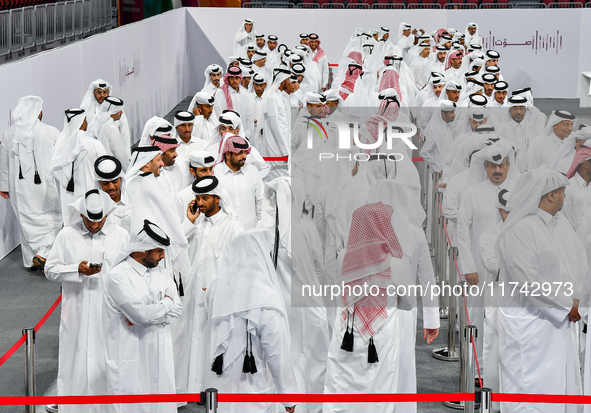 Qatari men wait in long queues to vote at a polling station in Doha, Qatar, on November 5, 2024, to cast their votes in a general referendum...