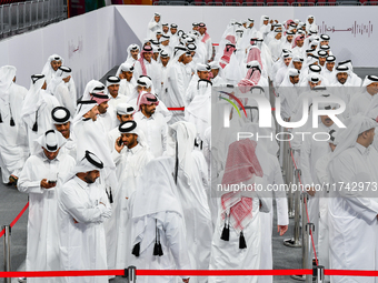 Qatari men wait in long queues to vote at a polling station in Doha, Qatar, on November 5, 2024, to cast their votes in a general referendum...