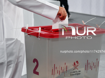 A Qatari man casts his ballot at a polling station in a general referendum on constitutional amendments, including scrapping advisory counci...