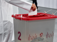 A Qatari man casts his ballot at a polling station in a general referendum on constitutional amendments, including scrapping advisory counci...