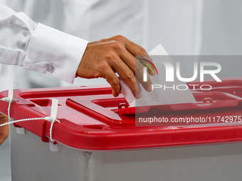 A Qatari man casts his ballot at a polling station in a general referendum on constitutional amendments, including scrapping advisory counci...