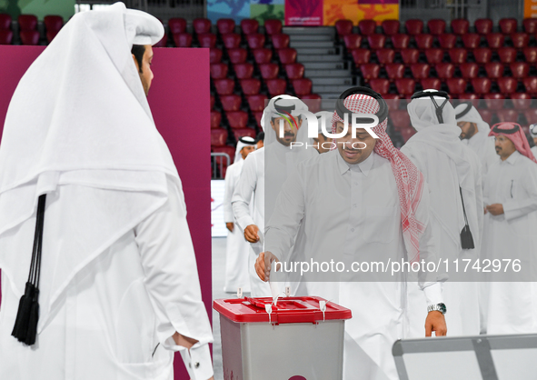 Qatari men cast their votes in ballot boxes at a polling station in a general referendum on constitutional amendments, including scrapping a...