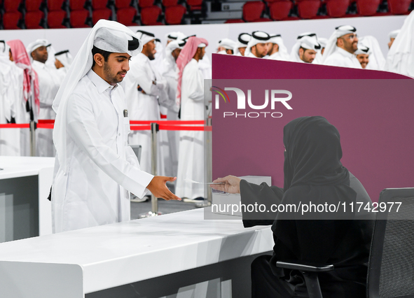 An electoral official checks the identification of a voter at a polling station to take part in a general referendum on constitutional amend...