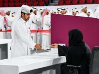 An electoral official checks the identification of a voter at a polling station to take part in a general referendum on constitutional amend...