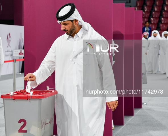 Qatari men cast their votes in ballot boxes at a polling station in a general referendum on constitutional amendments, including scrapping a...