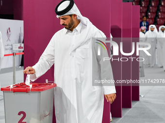 Qatari men cast their votes in ballot boxes at a polling station in a general referendum on constitutional amendments, including scrapping a...