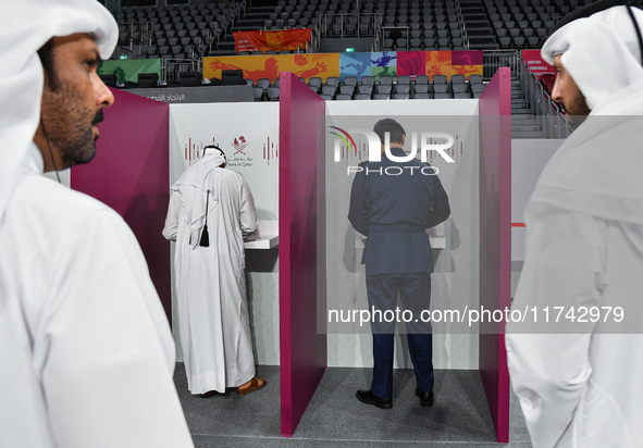 Qatari men cast their votes at a polling station in Doha, Qatar, on November 5, 2024, in a general referendum on constitutional amendments,...