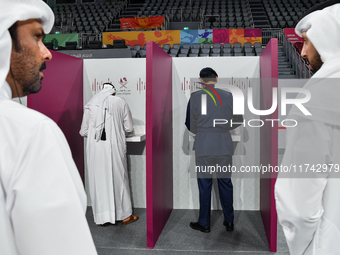 Qatari men cast their votes at a polling station in Doha, Qatar, on November 5, 2024, in a general referendum on constitutional amendments,...