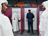 Qatari men cast their votes at a polling station in Doha, Qatar, on November 5, 2024, in a general referendum on constitutional amendments,...