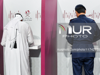 Qatari men cast their votes at a polling station in Doha, Qatar, on November 5, 2024, in a general referendum on constitutional amendments,...