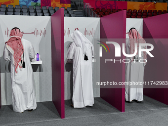 Qatari men cast their votes at a polling station in Doha, Qatar, on November 5, 2024, in a general referendum on constitutional amendments,...