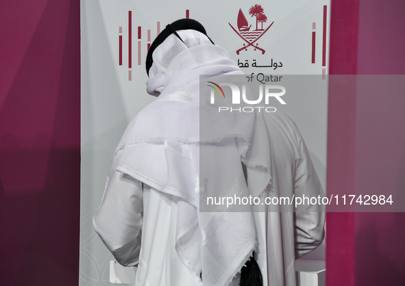 A Qatari man casts his ballot at a polling station in a general referendum on constitutional amendments, including scrapping advisory counci...