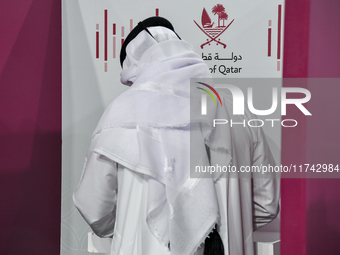 A Qatari man casts his ballot at a polling station in a general referendum on constitutional amendments, including scrapping advisory counci...