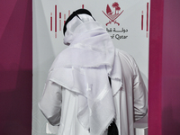 A Qatari man casts his ballot at a polling station in a general referendum on constitutional amendments, including scrapping advisory counci...