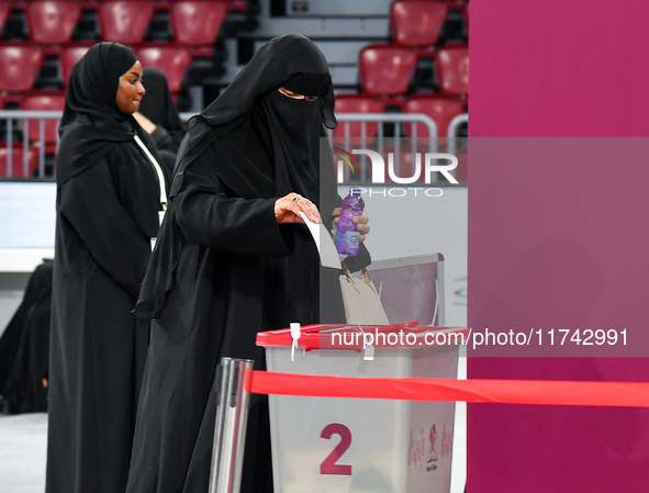 A Qatari woman casts her vote at a polling station in Doha, Qatar, on November 5, 2024, in a general referendum on constitutional amendments...