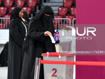 A Qatari woman casts her vote at a polling station in Doha, Qatar, on November 5, 2024, in a general referendum on constitutional amendments...