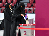 A Qatari woman casts her vote at a polling station in Doha, Qatar, on November 5, 2024, in a general referendum on constitutional amendments...