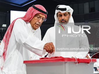 Qatari men cast their votes in ballot boxes at a polling station in a general referendum on constitutional amendments, including scrapping a...