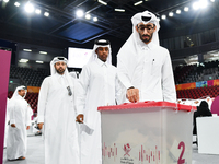 Qatari men cast their votes in ballot boxes at a polling station in a general referendum on constitutional amendments, including scrapping a...