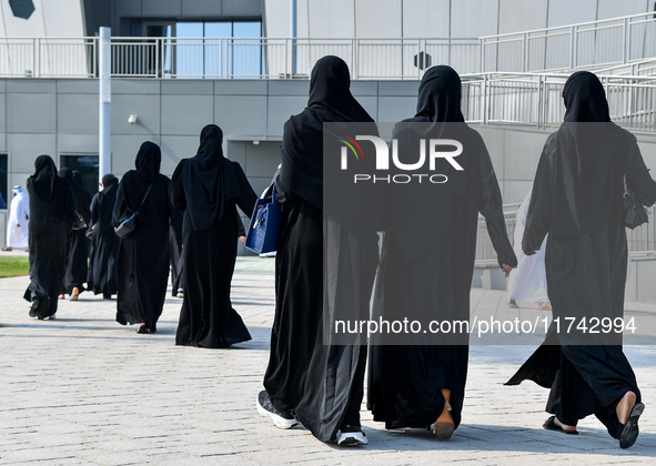 Qatari women arrive at a polling station in Doha, Qatar, on November 5, 2024, to cast their votes in a general referendum on constitutional...