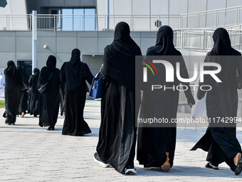 Qatari women arrive at a polling station in Doha, Qatar, on November 5, 2024, to cast their votes in a general referendum on constitutional...