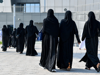 Qatari women arrive at a polling station in Doha, Qatar, on November 5, 2024, to cast their votes in a general referendum on constitutional...