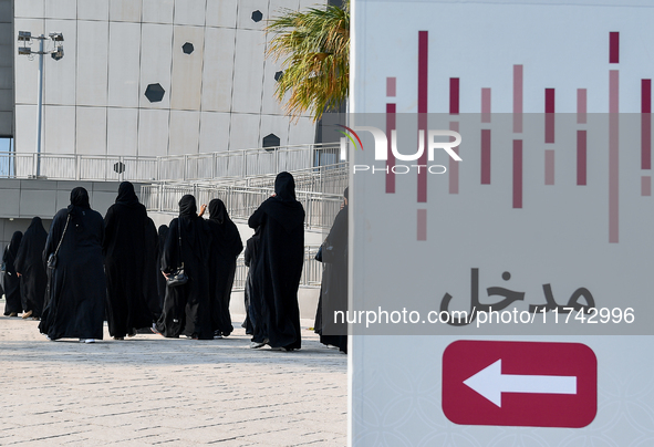 Qatari women arrive at a polling station in Doha, Qatar, on November 5, 2024, to cast their votes in a general referendum on constitutional...