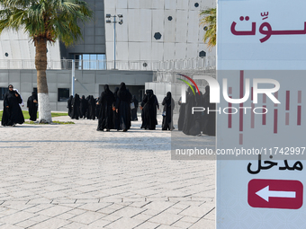 Qatari women arrive at a polling station in Doha, Qatar, on November 5, 2024, to cast their votes in a general referendum on constitutional...