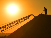 Sea salt from the autumn harvest is stacked on a conveyor belt at the Dongfeng Salt Farm in Hetao Street, Chengyang district, in Qingdao, Ch...