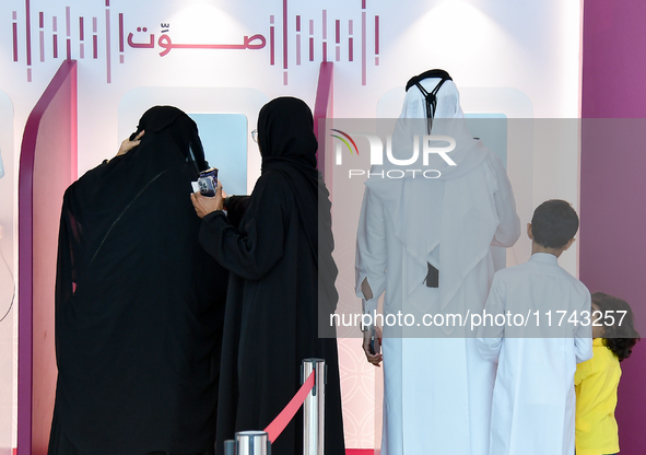 Qatari voters cast their electronic votes at a polling station in a general referendum on constitutional amendments, including scrapping adv...