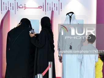 Qatari voters cast their electronic votes at a polling station in a general referendum on constitutional amendments, including scrapping adv...