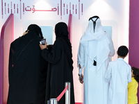 Qatari voters cast their electronic votes at a polling station in a general referendum on constitutional amendments, including scrapping adv...