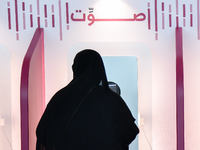 A Qatari woman casts her electronic vote at a polling station in Doha, Qatar, on November 5, 2024, in a general referendum on constitutional...