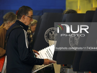 Americans cast their ballots in the presidential election in downtown New York, United States, on November 5, 2024, at the Institute of Art...