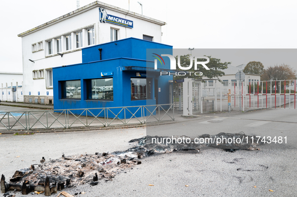 CGT union representatives and workers burn tires during a demonstration in front of the Michelin plant in Vannes, France, on November 5, 202...