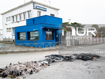 CGT union representatives and workers burn tires during a demonstration in front of the Michelin plant in Vannes, France, on November 5, 202...