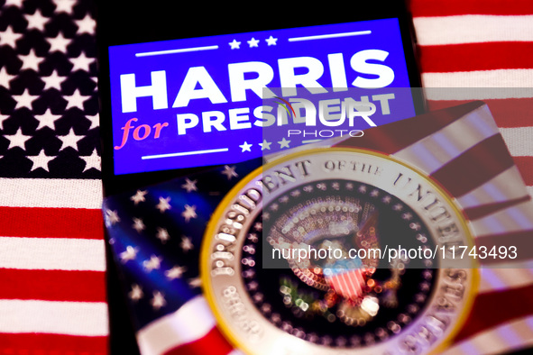 'Harris for President' sign is displayed on a mobile phone screen with US flag in the background for illustration photo. Krakow, Poland on N...