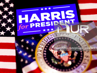 'Harris for President' sign is displayed on a mobile phone screen with US flag in the background for illustration photo. Krakow, Poland on N...