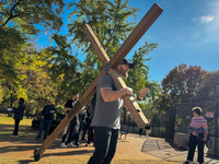 A man carries a large wooden cross near the White House in Washington DC, USA on 05 November, 2024. (