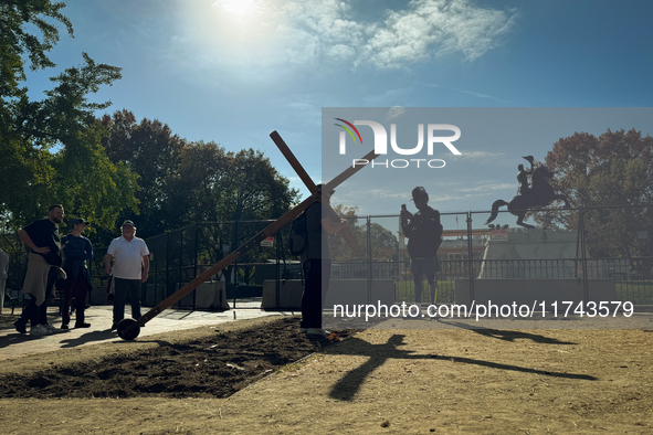 A man carries a large wooden cross near the White House in Washington DC, USA on 05 November, 2024. 